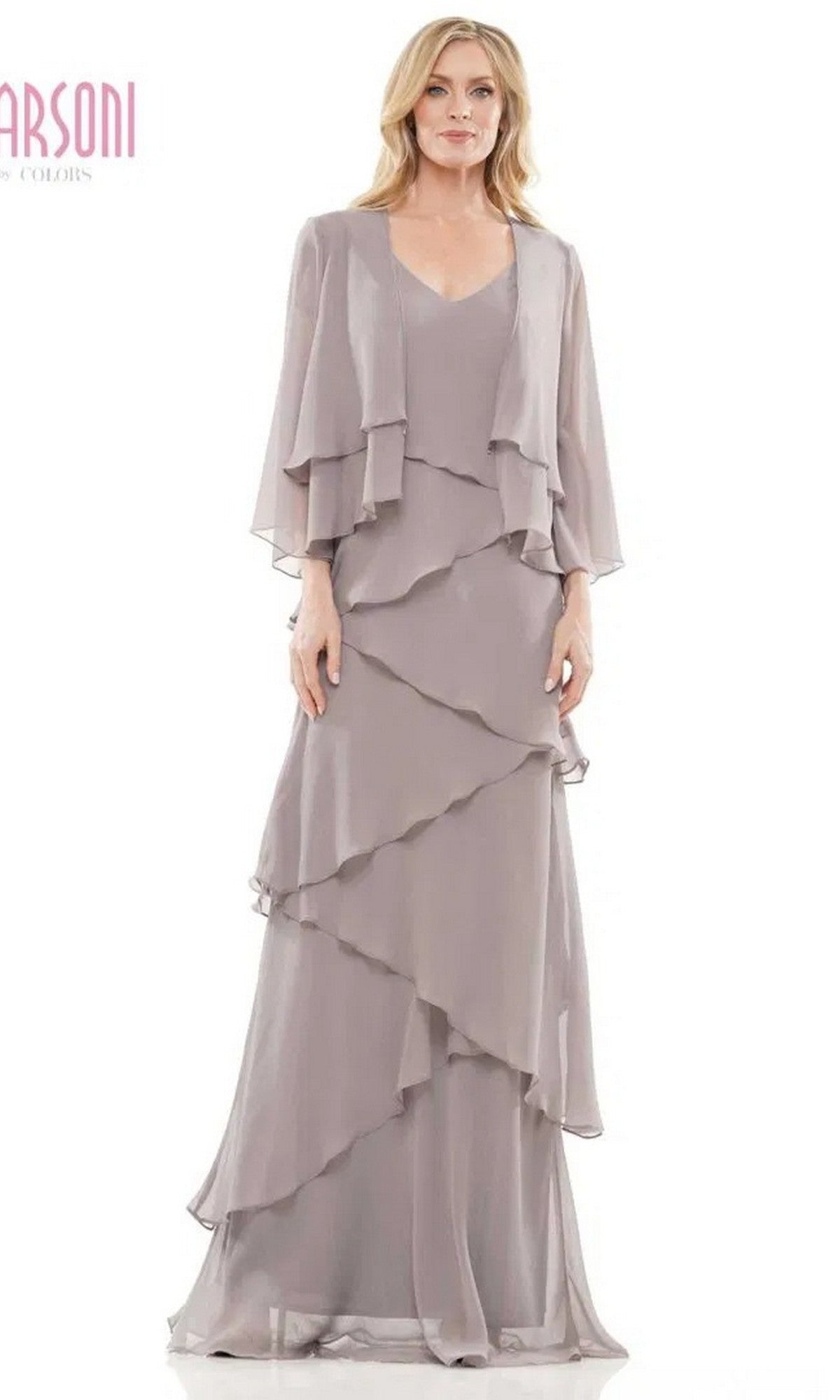 A woman stands against a plain white background wearing the Marsoni M309 long formal dress in grey—a floor-length, layered chiffon gown with a matching draped jacket, perfect for mothers of the bride.